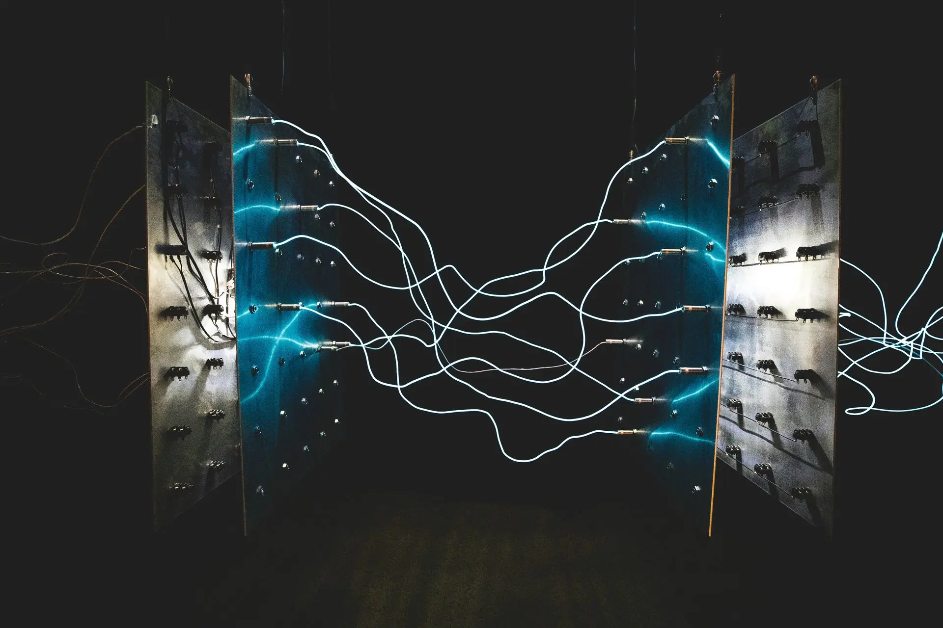 Two glowing blue LED light panels in a dark space